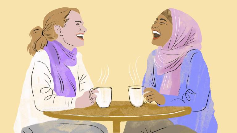 An illustration of two women laughing and talking over coffee at a cafe.