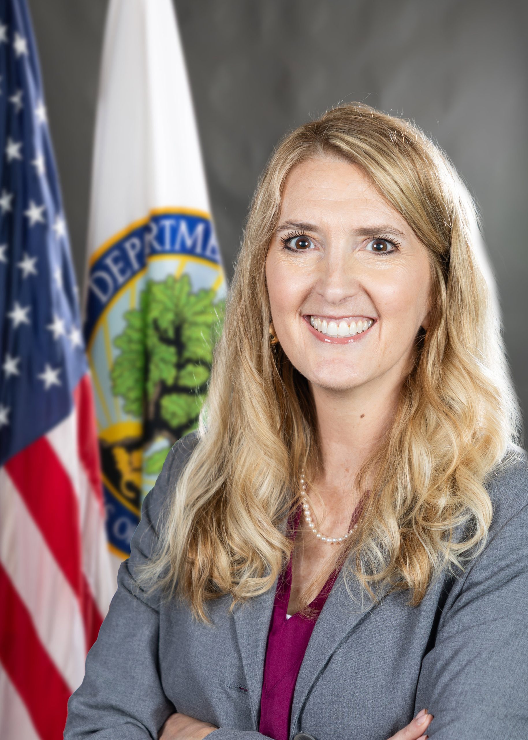 Woman standing in front of two flags