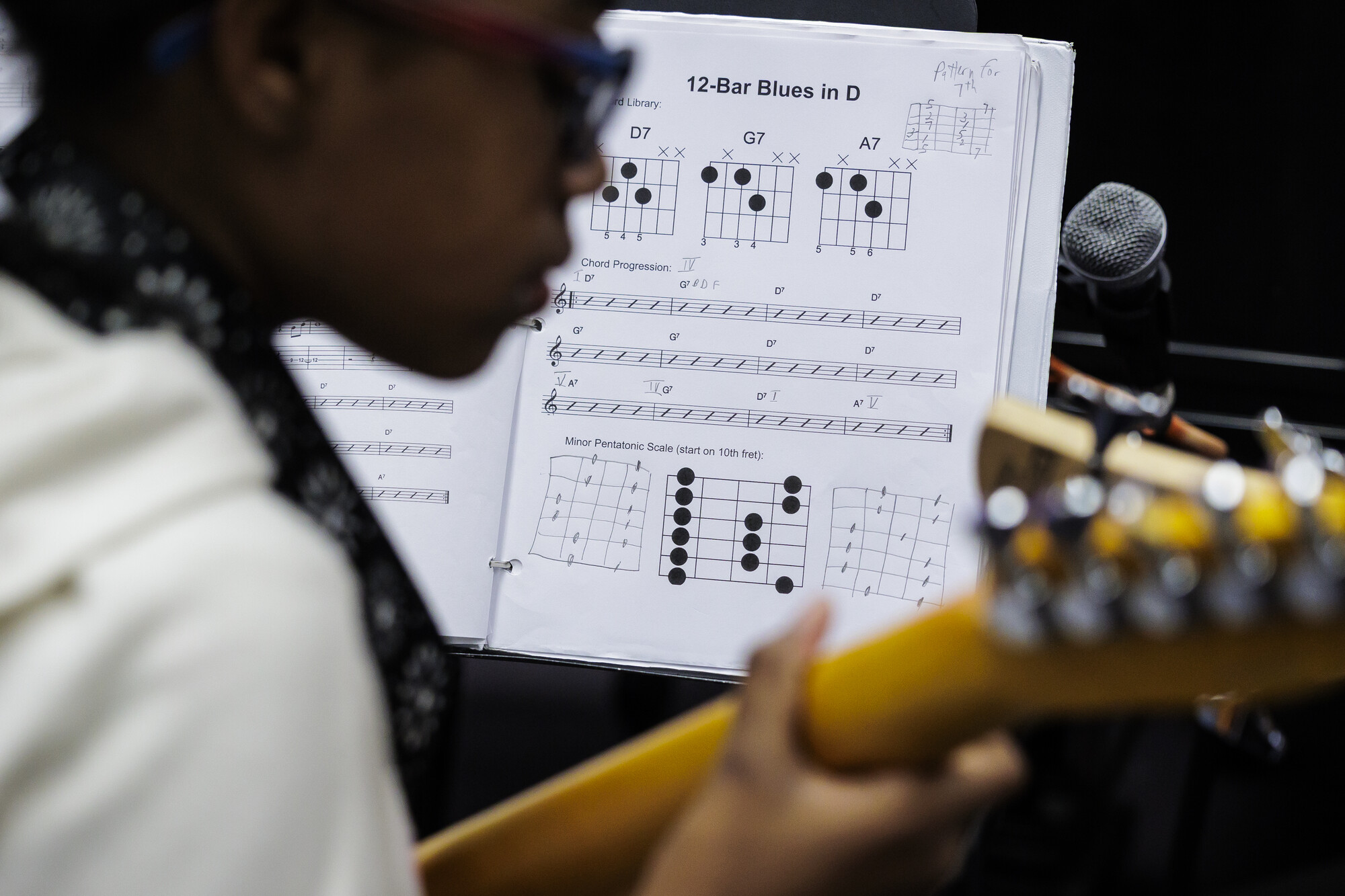 Student holding guitar