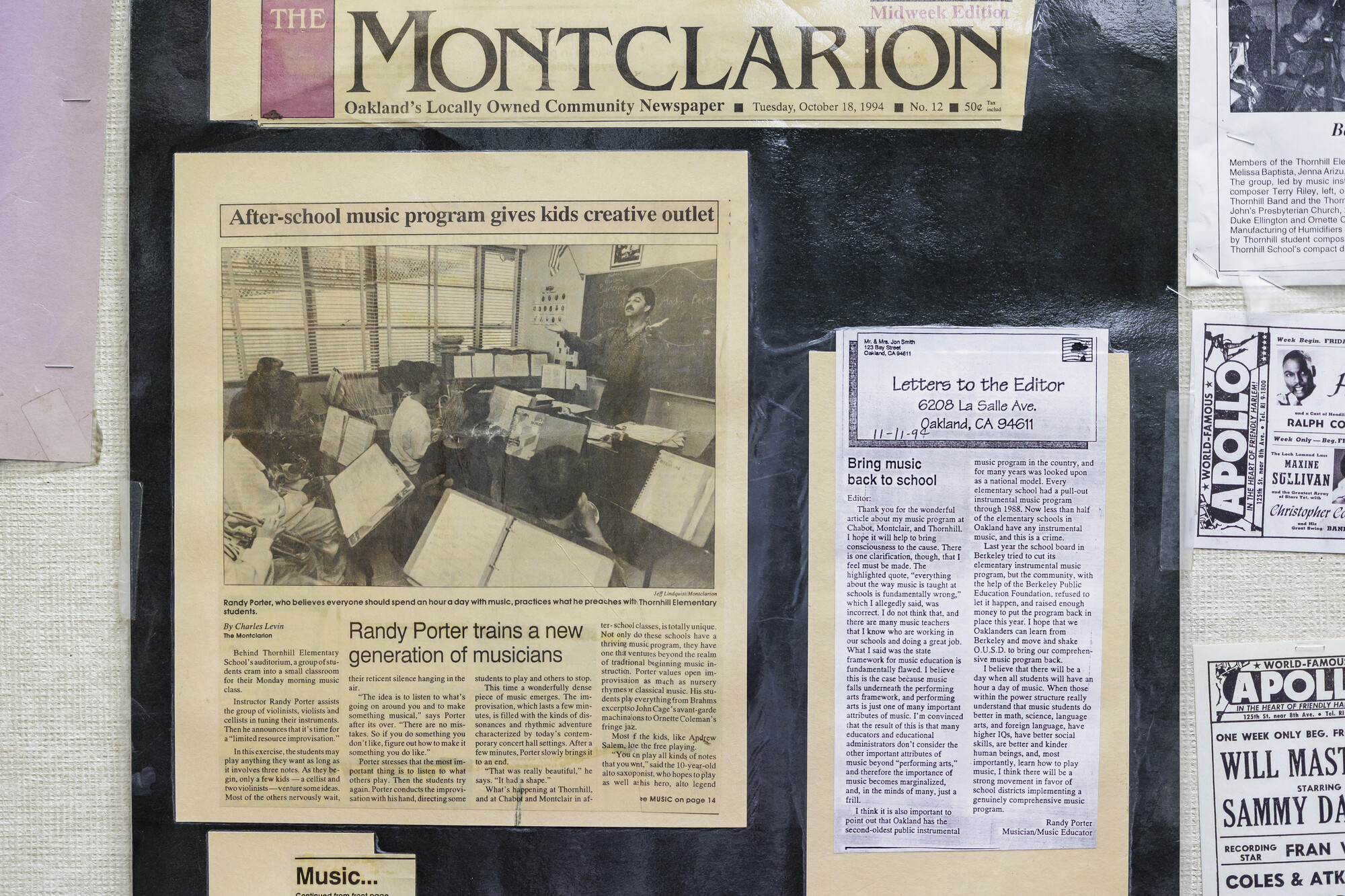 Photo of newspaper clipping on a wall.