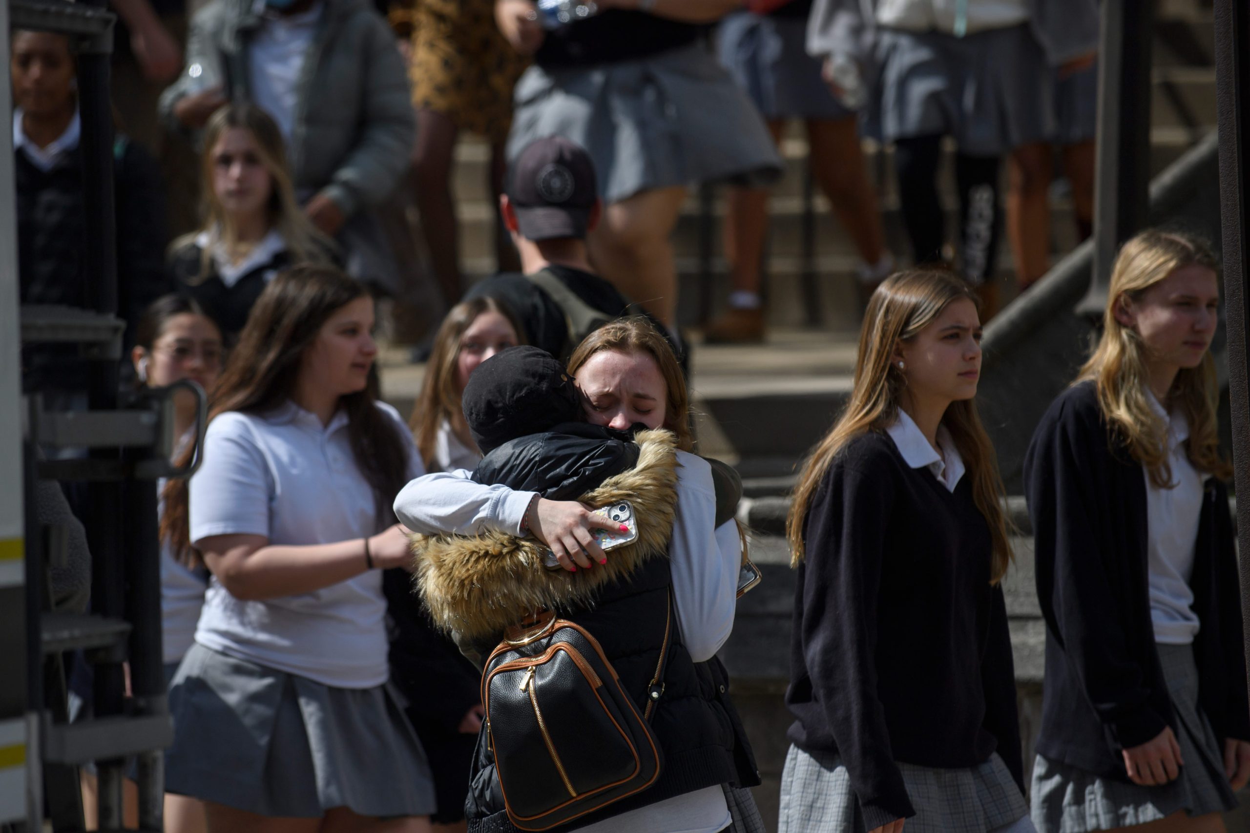Students consoling one another at school