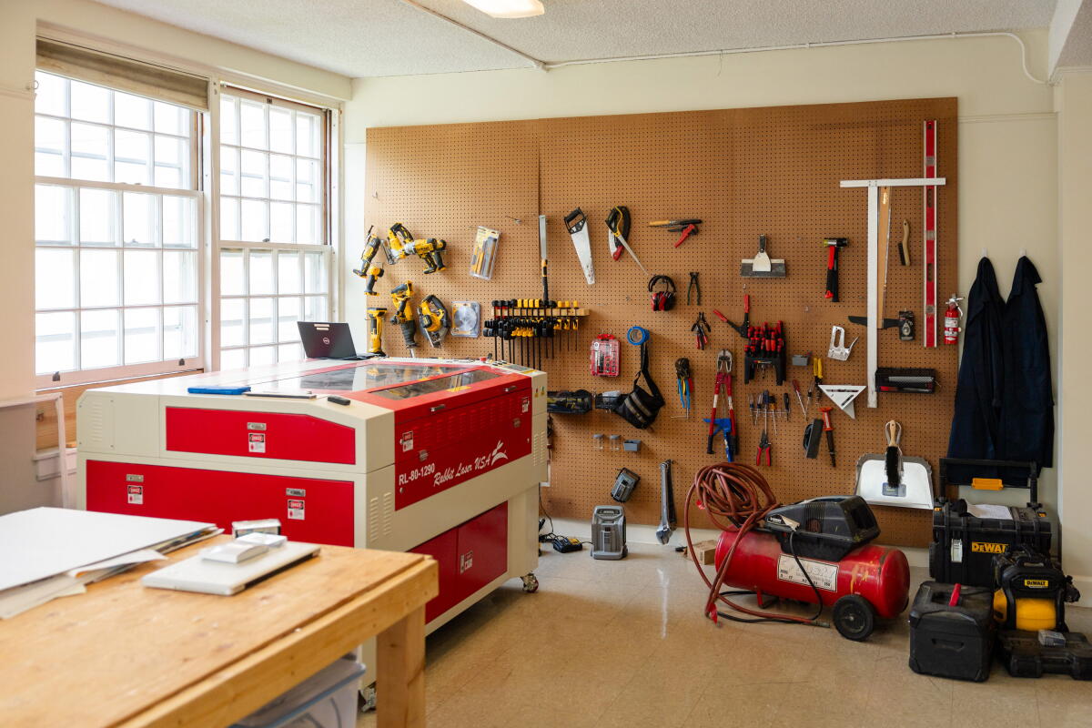 Room with a a wall of tools and other craft-making equipment