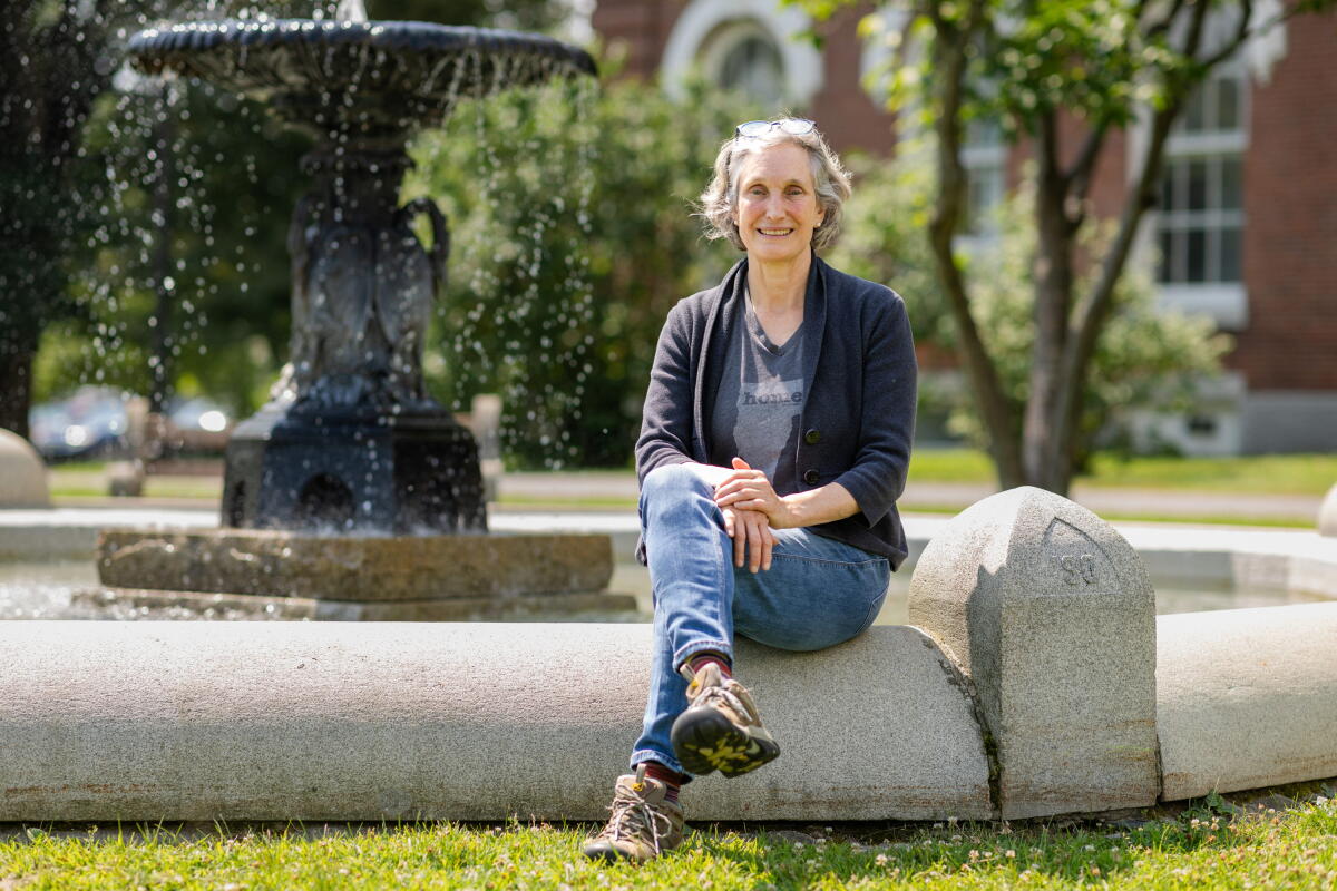 Woman seated in front of a fountain