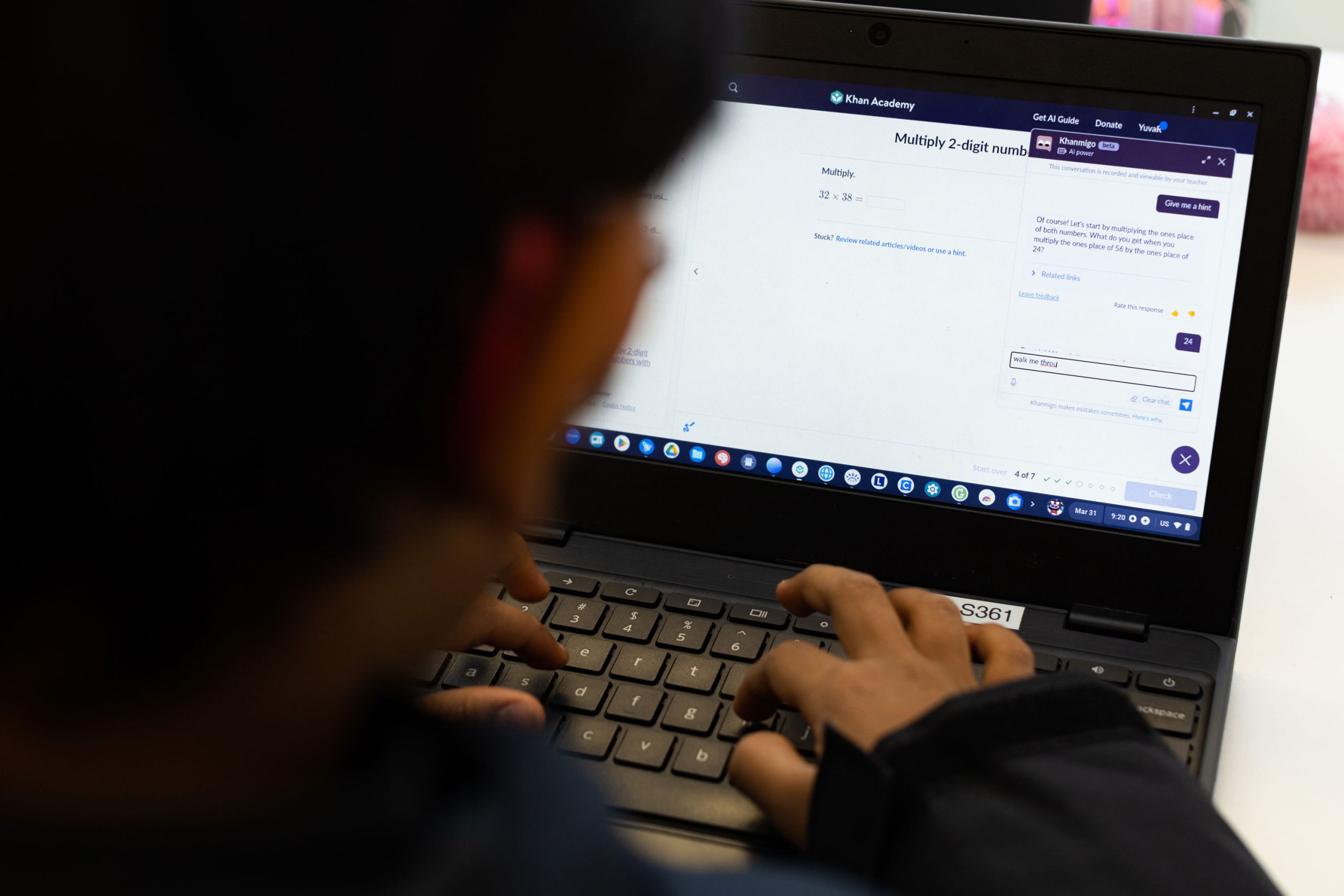 Student typing on a laptop