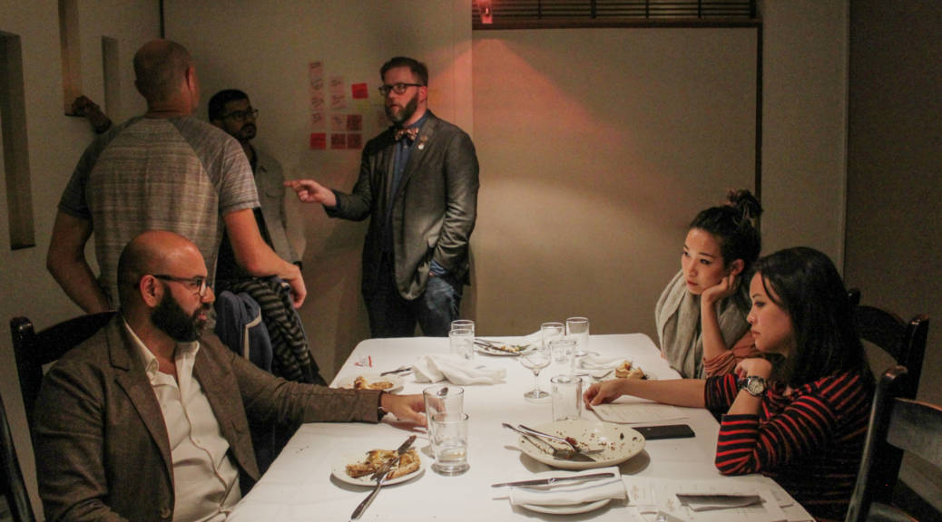 Make America Dinner Again guest Affan Khokhar (left, seated) talks with hosts Tria Chang and Justine Lee (front right, seated) after the dinner as guests (from left to right) Afam Agbodike, Walter Rodriguez and Nick Tucker continue their conversation.
