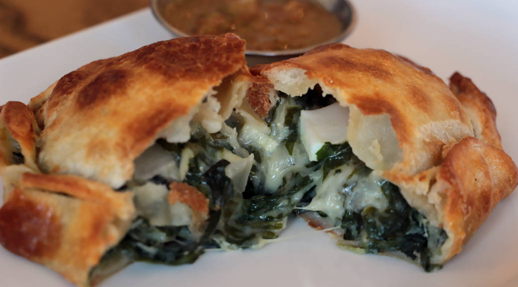 El Sur's vegetarian verde empanada with Swiss chard, spinach, onion, cheese sauce, olive and egg