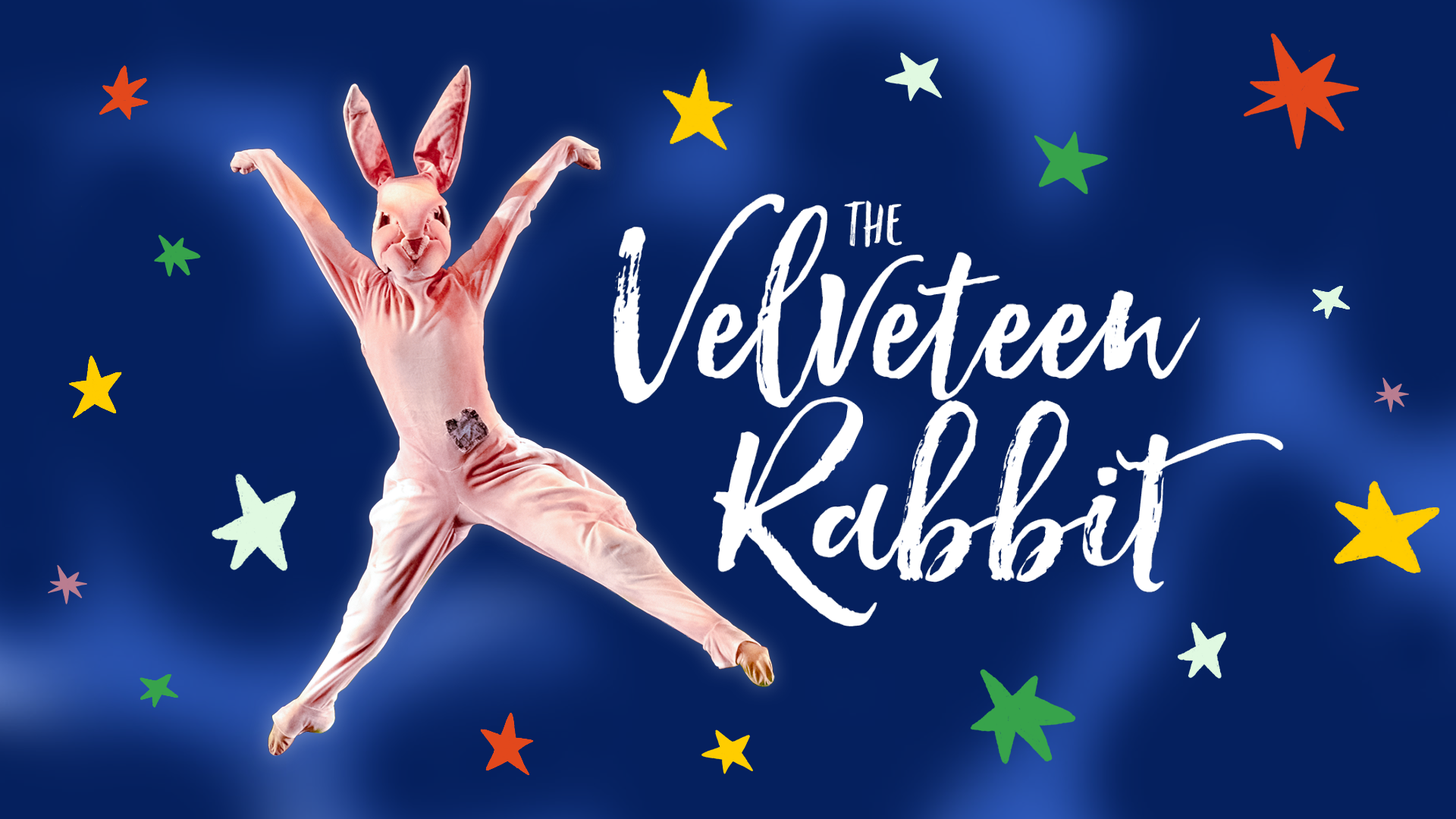 A dancer in a pink rabbit costume in the air with "The Velveteen Rabbit" written to the right with stars in the background.