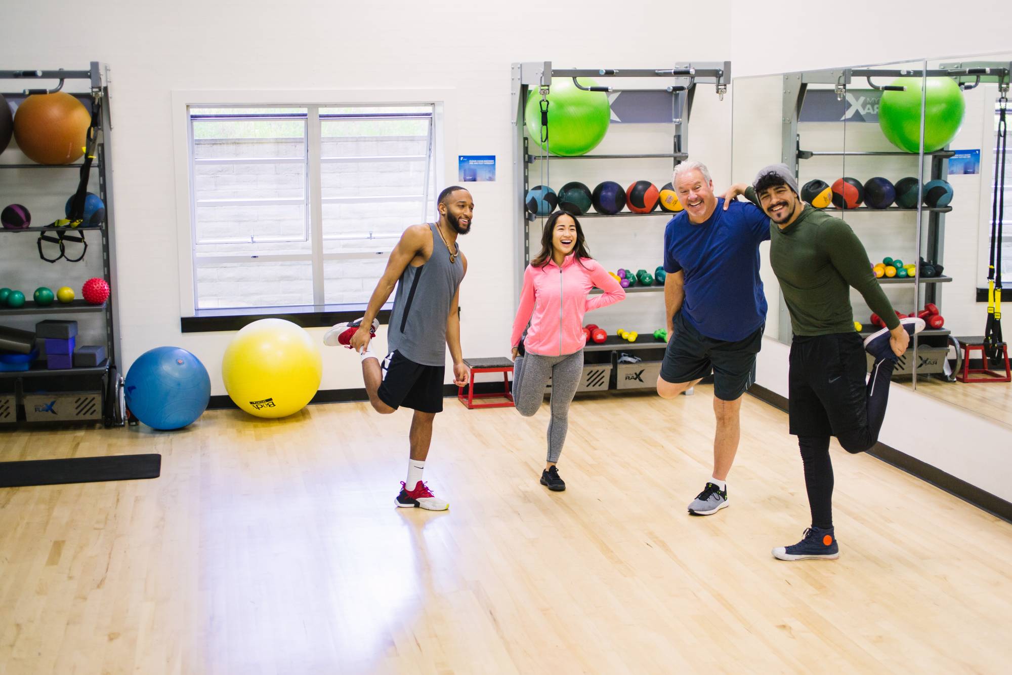 Four people stretching their legs