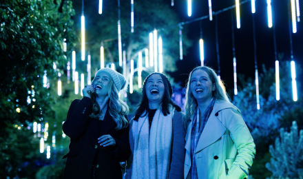 Three people looking at bright lights