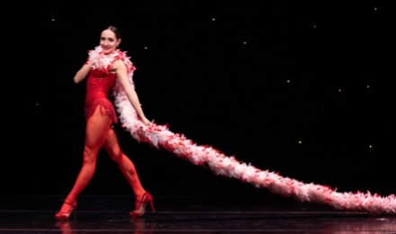 Woman wearing a long feather boa on stage