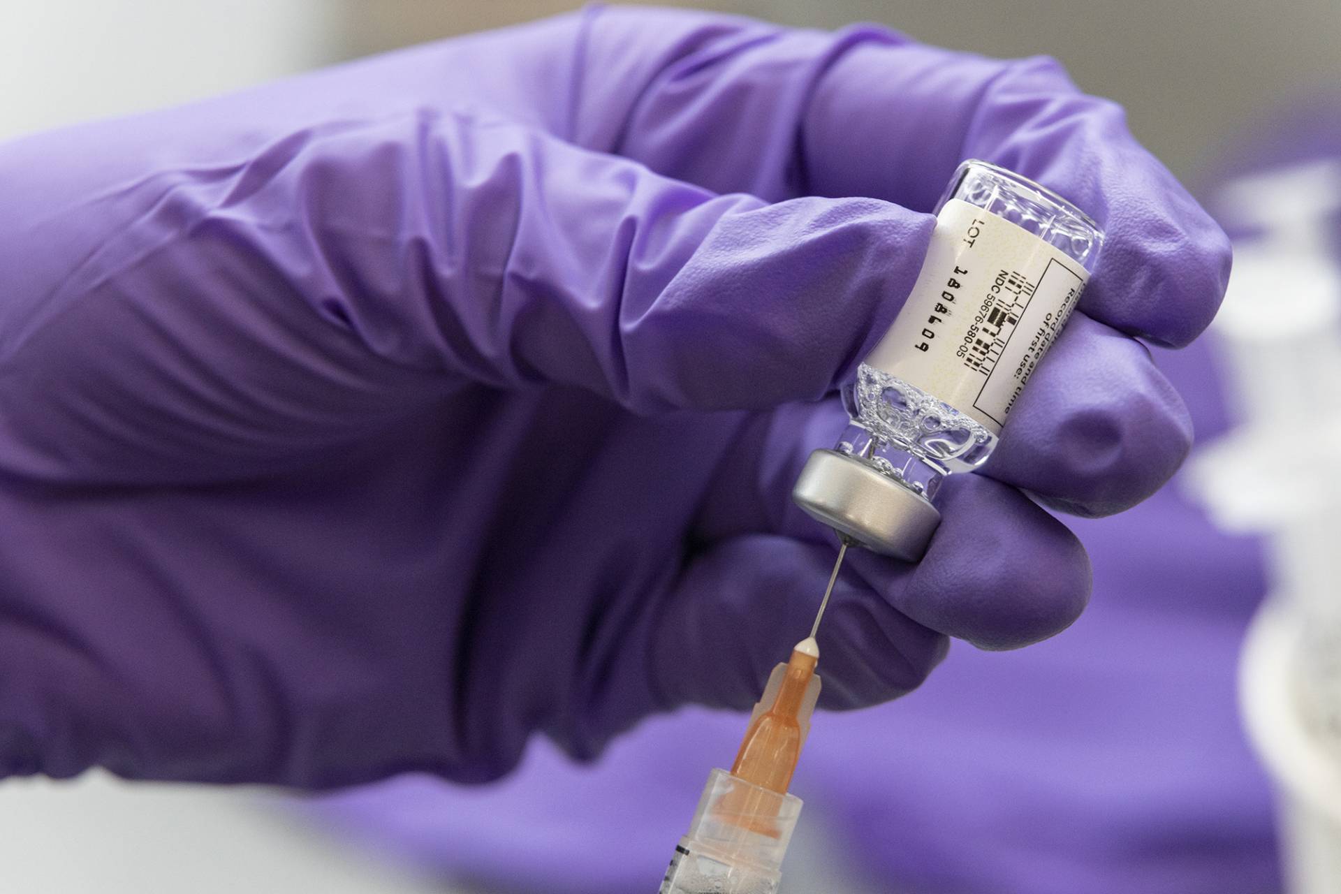 A gloved hand loads a syringe with the Covid-19 Johnson & Johnson vaccine.