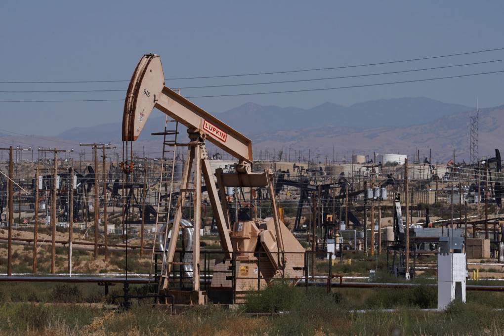 An oil pump is shown beneath a dusty sky.
