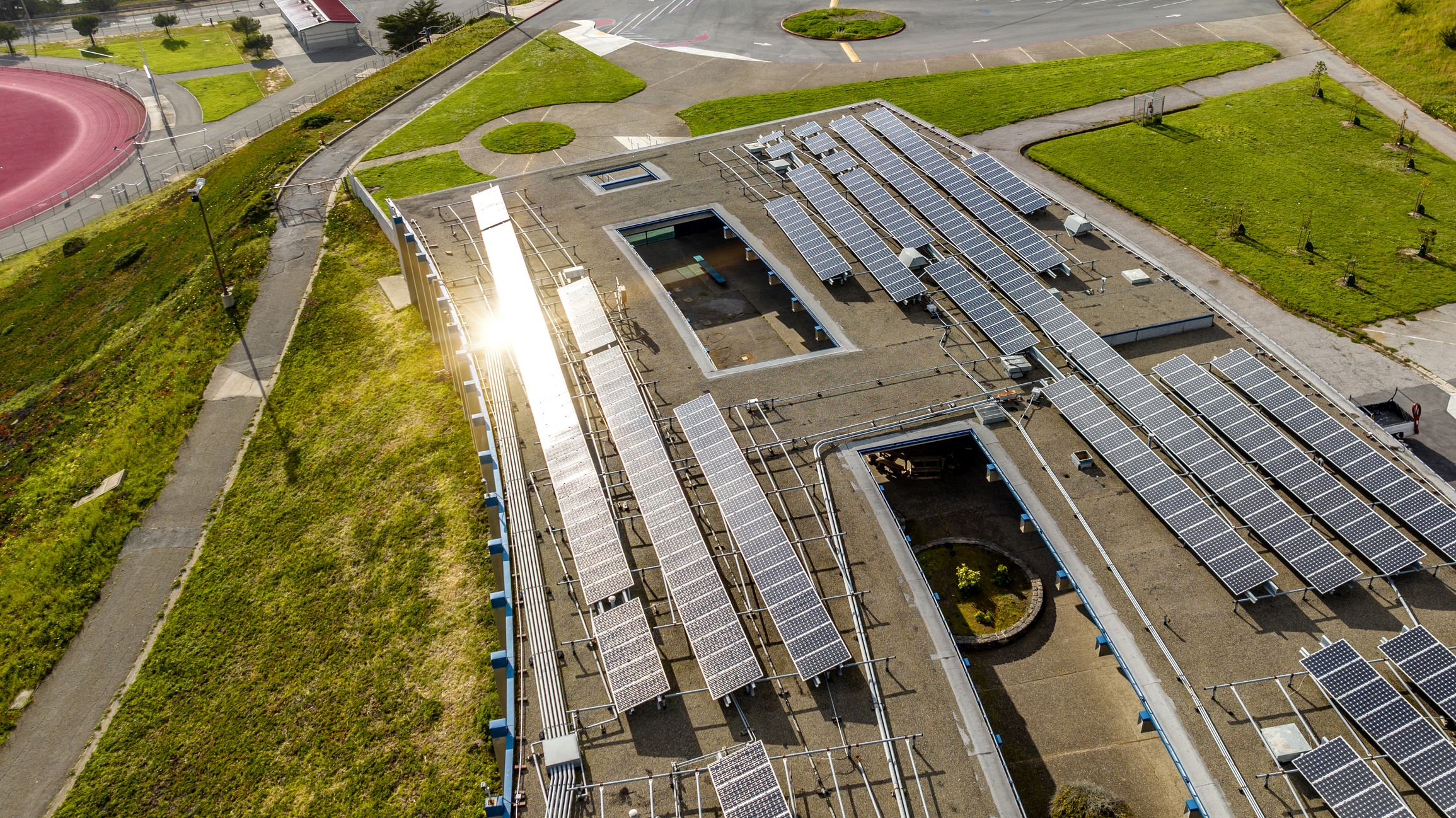 Solar panels on top of a building seen from the air.