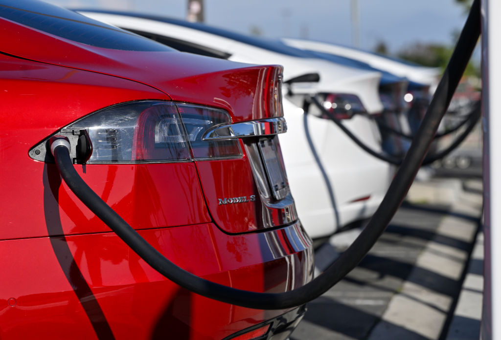 Electric vehicles lined up while charging.