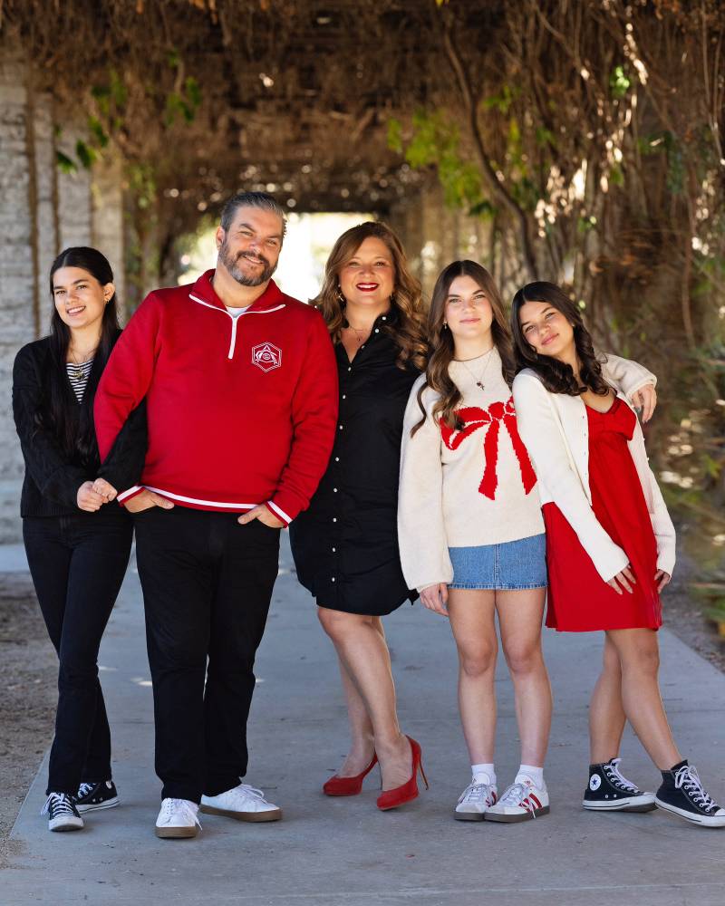 A portrait of a wife and husband and three daughters.