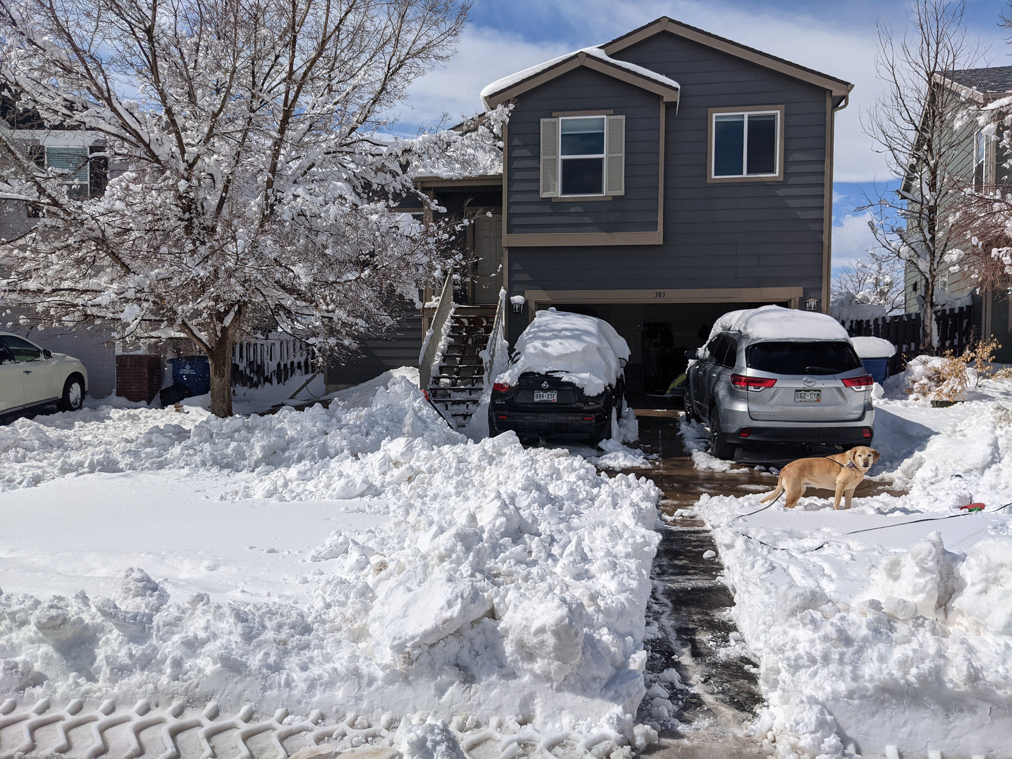 A two-story home, with snow covering the yard in front.