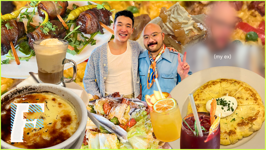 Joel Kim Booster, a smiling Korean American man in his 30s wearing a tank top and sweater, stands with his arm around Josh Decolongon, a 30s bald Filipino man with glasses wearing a blue denim jumpsuit. They are surrounded by tapas.