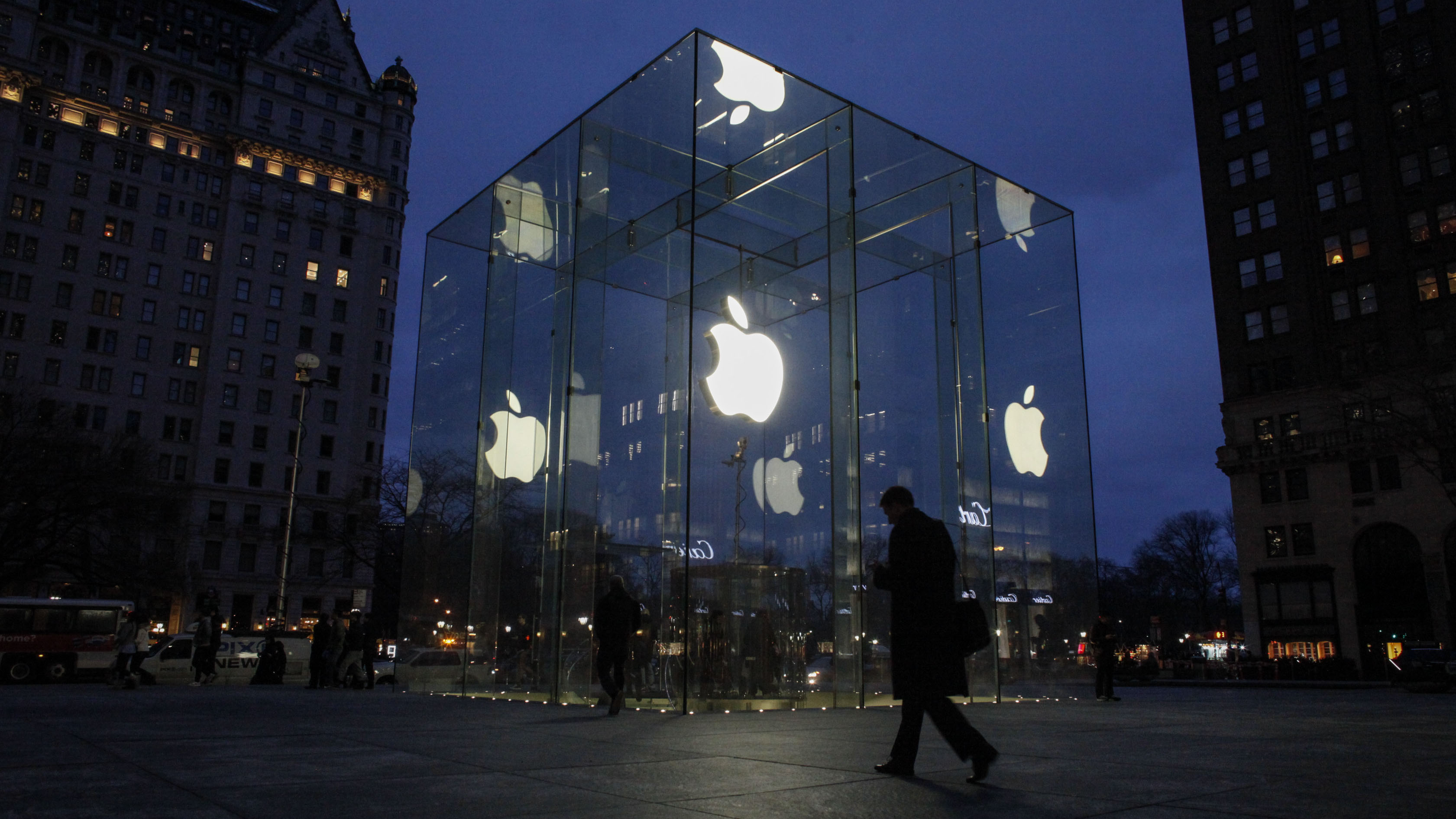 A man walks in front of the Apple Store.