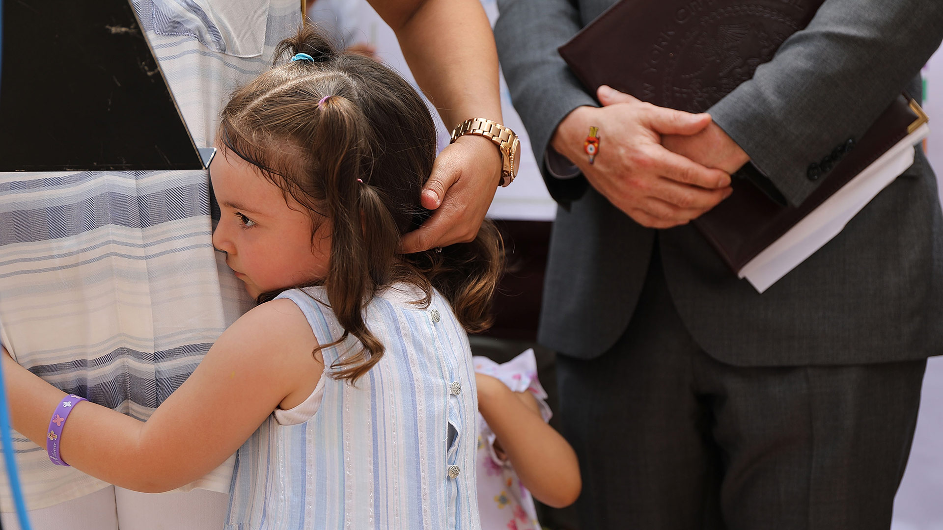 Luciana hugs her mother Sandra Chica, the wife of Pablo Villavicencio, an immigrant deliveryman who was detained by Immigration and Customs Enforcement agents while delivering pizza to Fort Hamilton Army base in Brooklyn, at a news conference on June 18, 2018 in New York City. On Monday Chica filed a formal request for his release with ICE's Enforcement and Removal Operations branch.