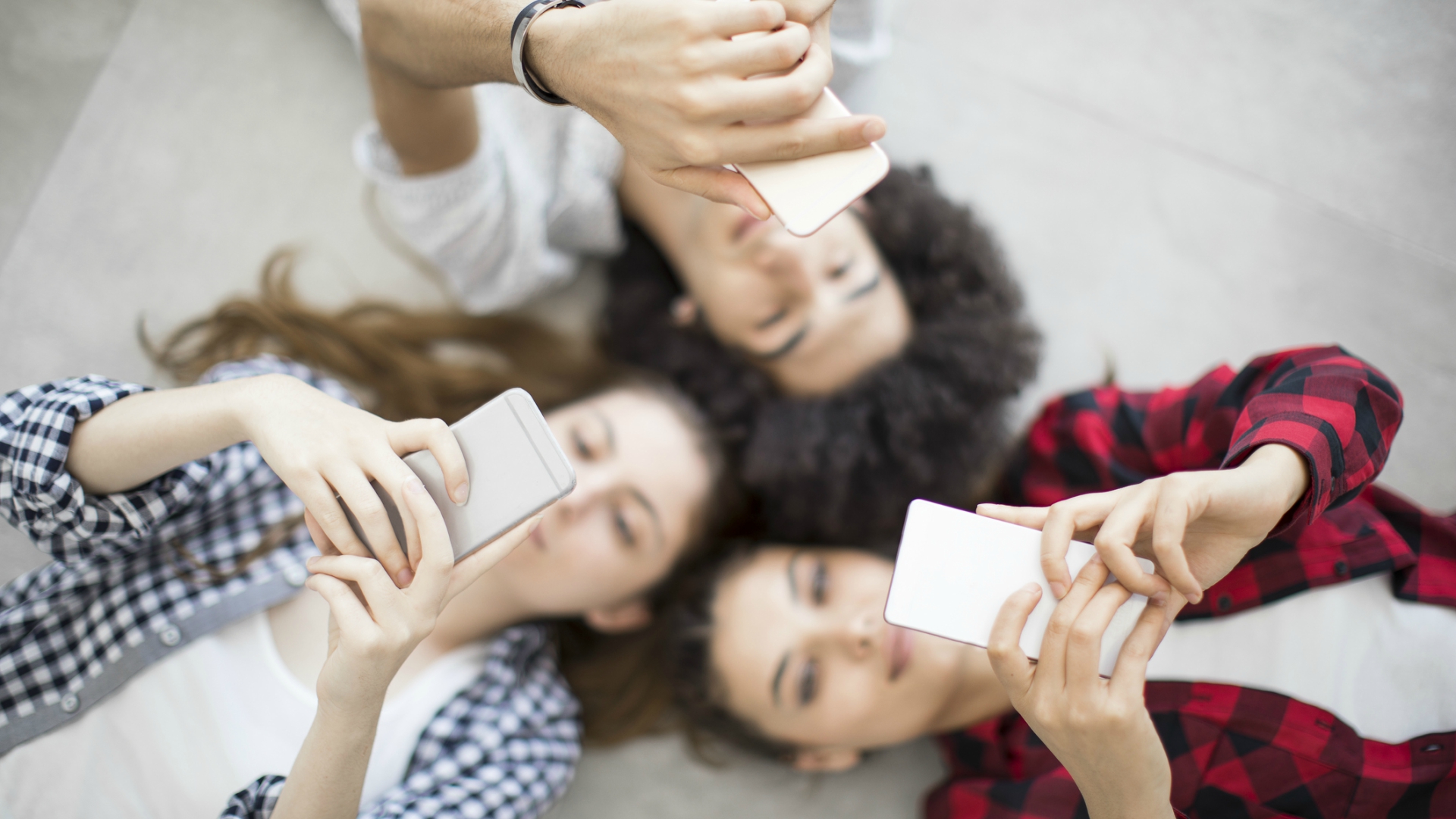 Teens looking at their phone.