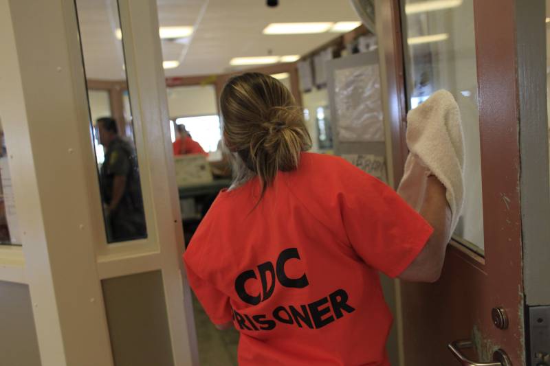 A woman cleans a window while working at the reception center