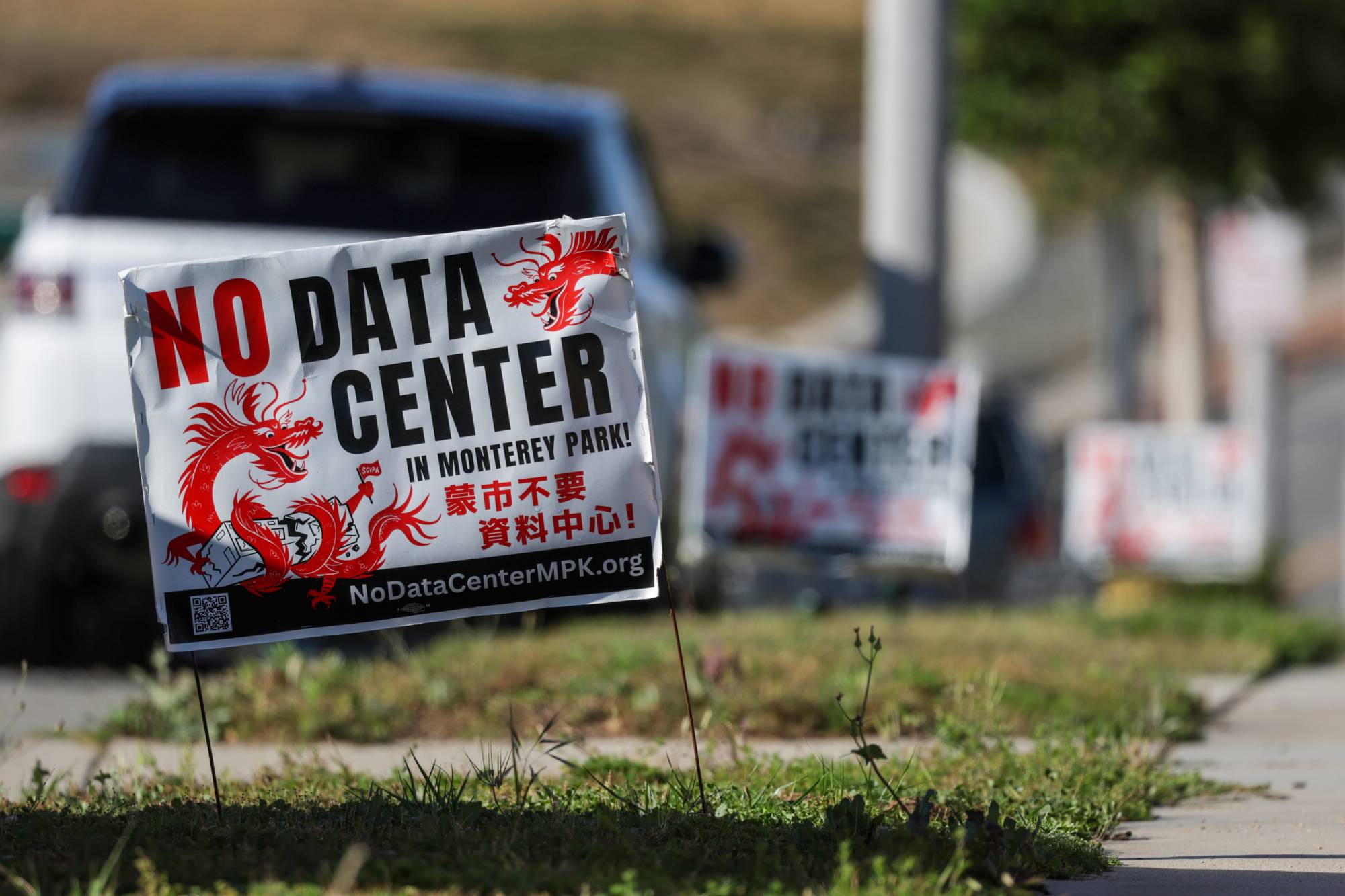 Yard protest signs say "No Data Center"