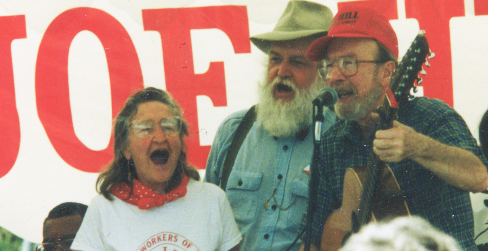 Faith Petric, Bruce “Utah” Philips, and Pete Seeger (left to right) singing together at a 1990 concert in Salt Lake City.