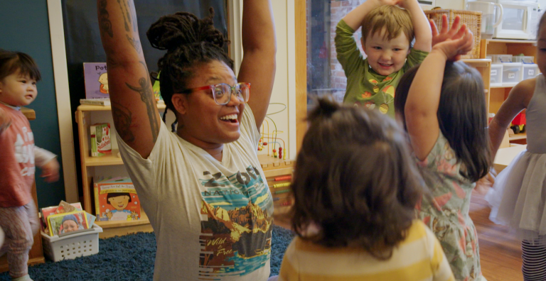 Infant-toddler teacher Leila Leo leads circle time with her students.