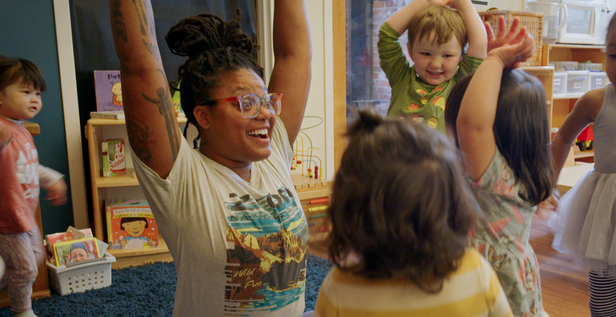 Infant-toddler teacher Leila Leo leads circle time with her students.