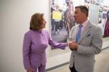 Nancy Pelosi talking with KQED reporter Scott Shafer, placing a hand gently on his arm in a hallway.