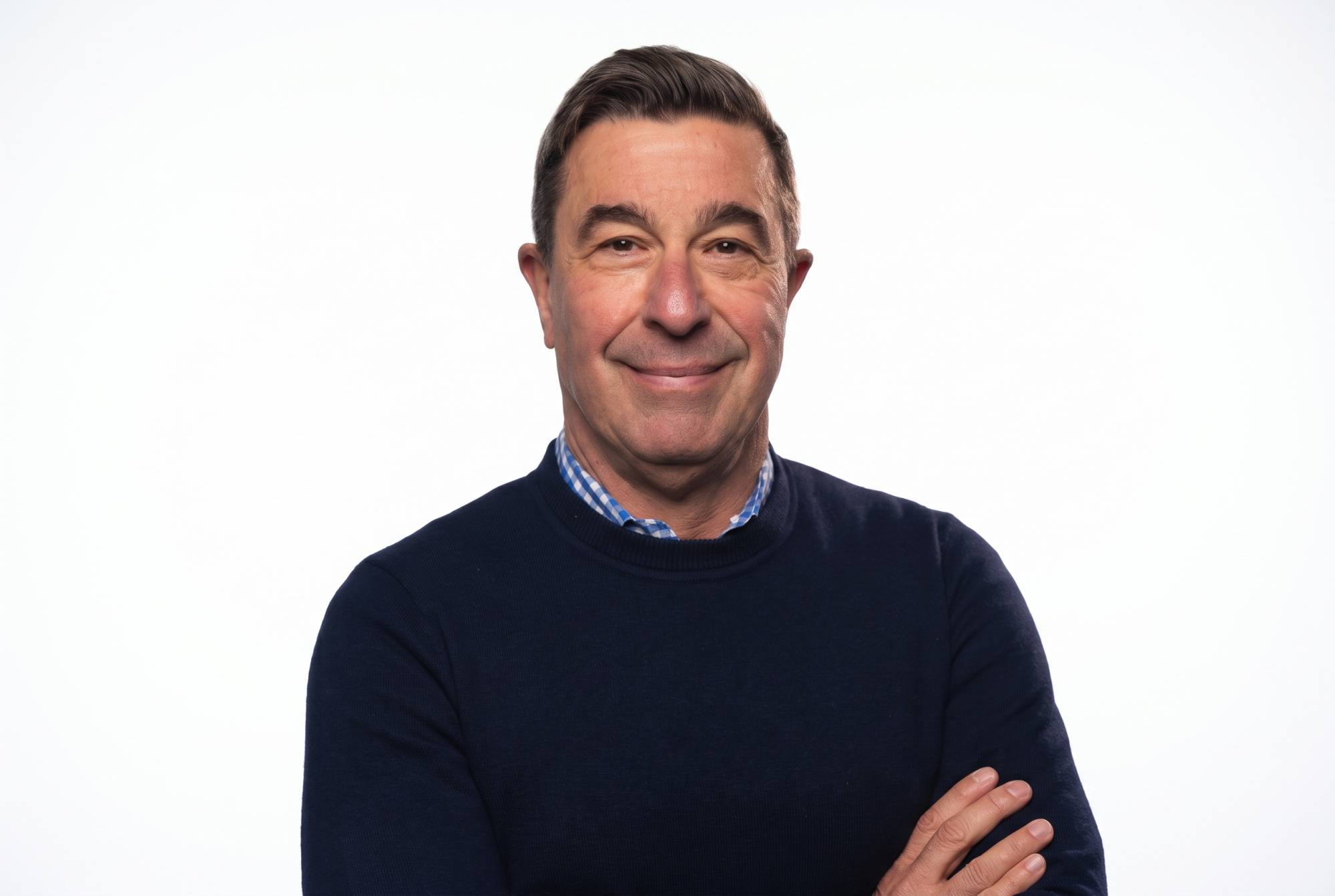 Headshot of KQED reporter Scott Shafer smiling with arms crossed against a plain white background.