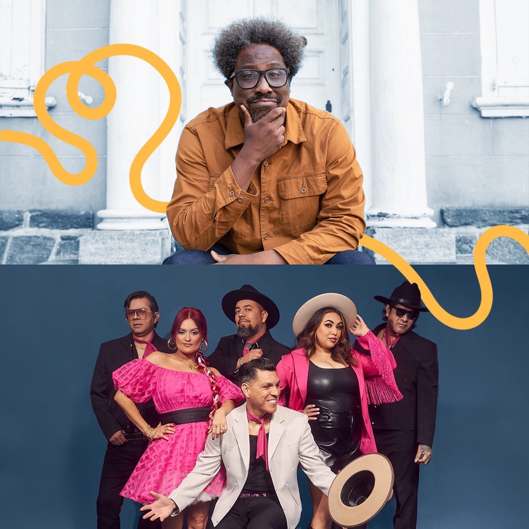 Comedia W. Kamau Bell in a yellow shirt next to members of the Chicano band Las Cafeteras stand together wearing black, pink, and white -- some of them in wide-brimmed hats