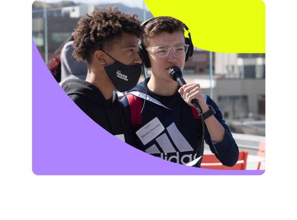 Two students, one with a microphone and headphones